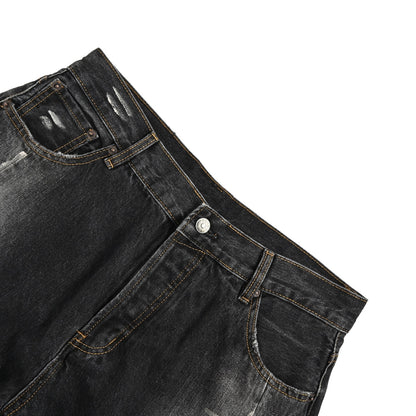 Acne Studios distressed scimitar jeans with splashes of ink
