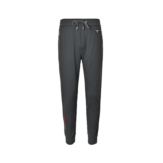 Prada triangle logo red tape trousers