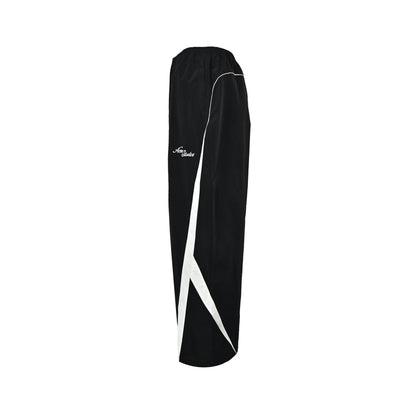 Acne Studios black and white patchwork embroidered logo trousers