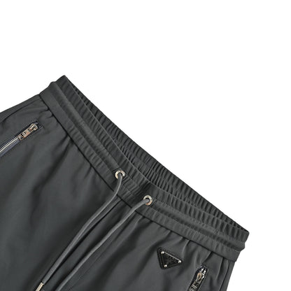 Prada triangle logo red tape trousers