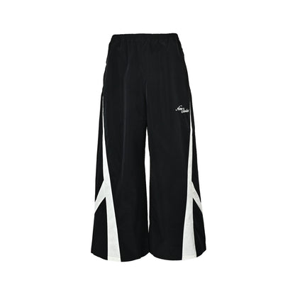 Acne Studios black and white patchwork embroidered logo trousers