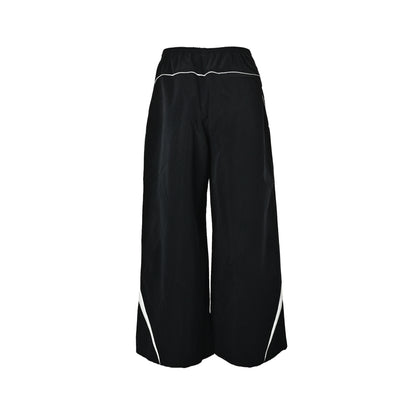 Acne Studios black and white patchwork embroidered logo trousers